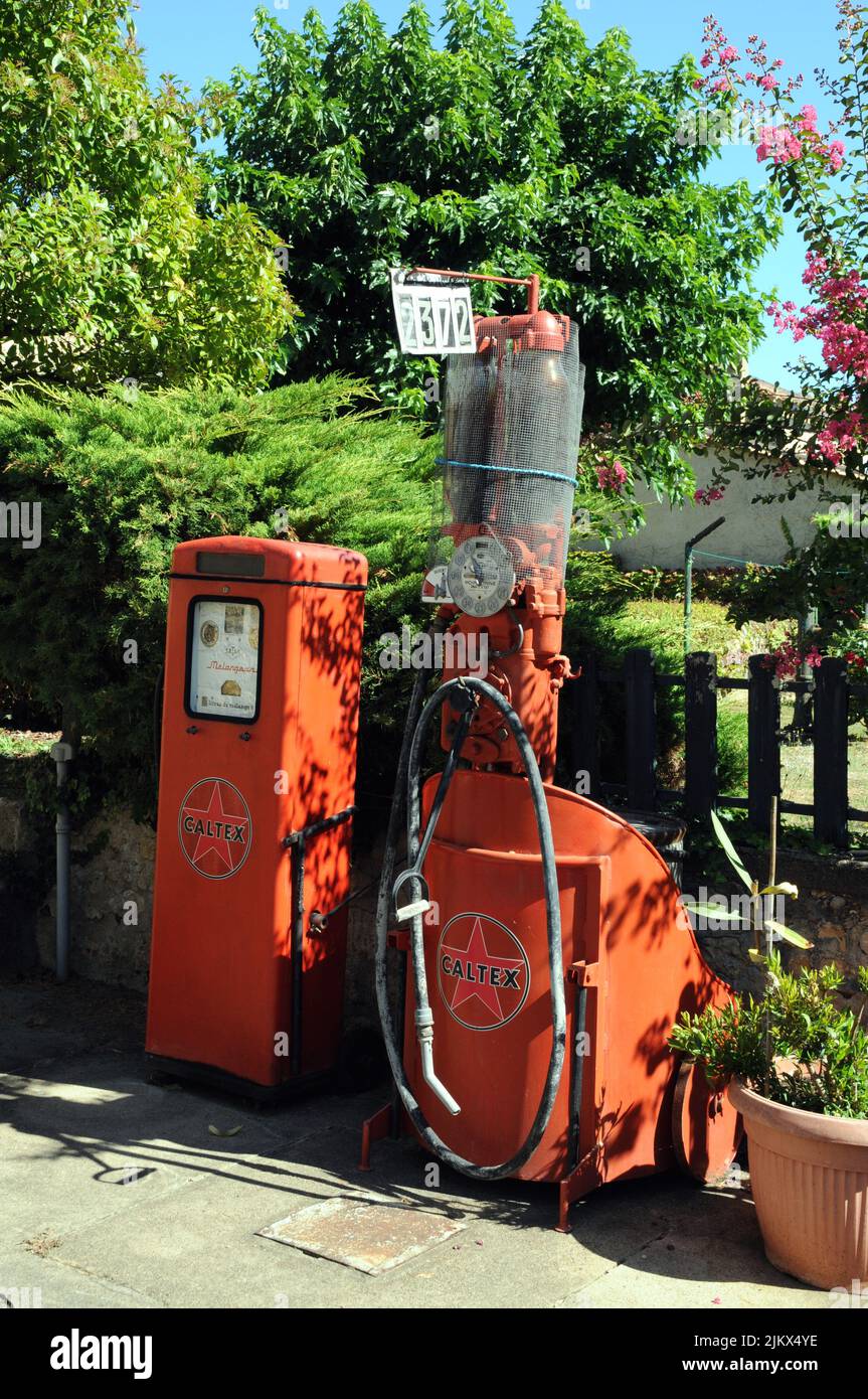 Historic pumps for petrol and two stroke in the village of Molières in the Dordogne department of south west France. Stock Photo