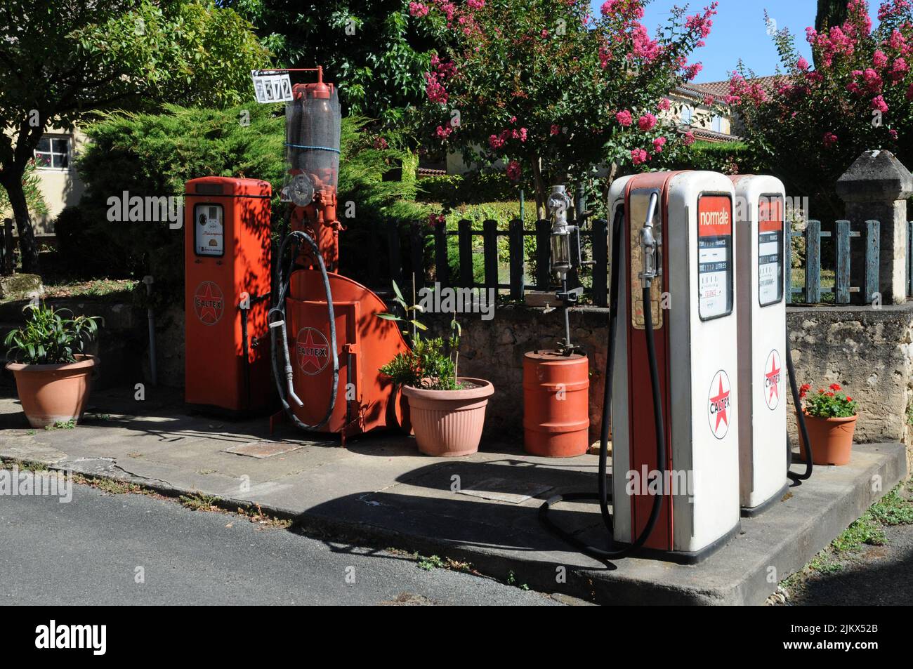 Historic pumps for petrol and two stroke in the village of Molières in the Dordogne department of south west France. Stock Photo