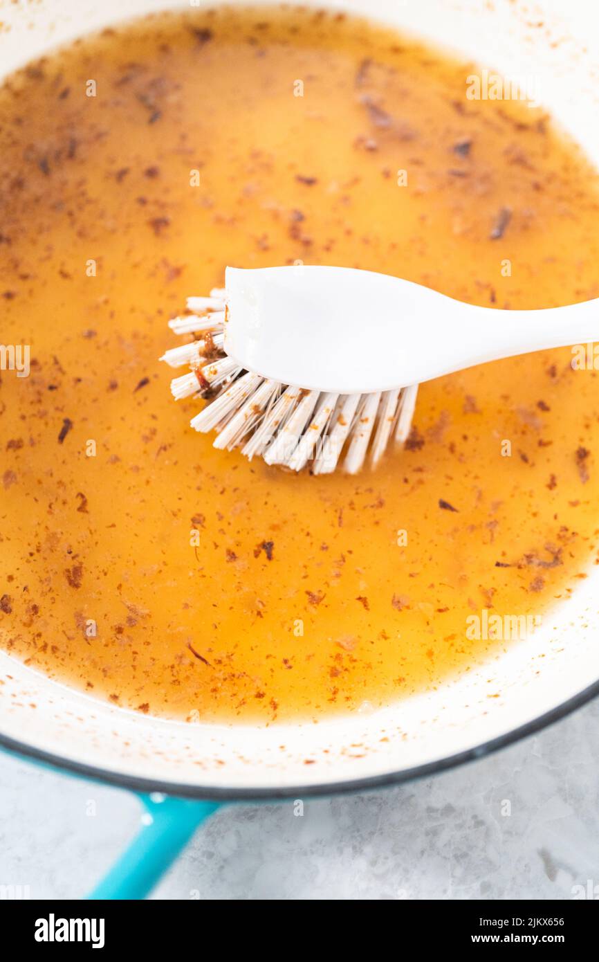 Cleaning cast iron blue enameled braiser Stock Photo - Alamy