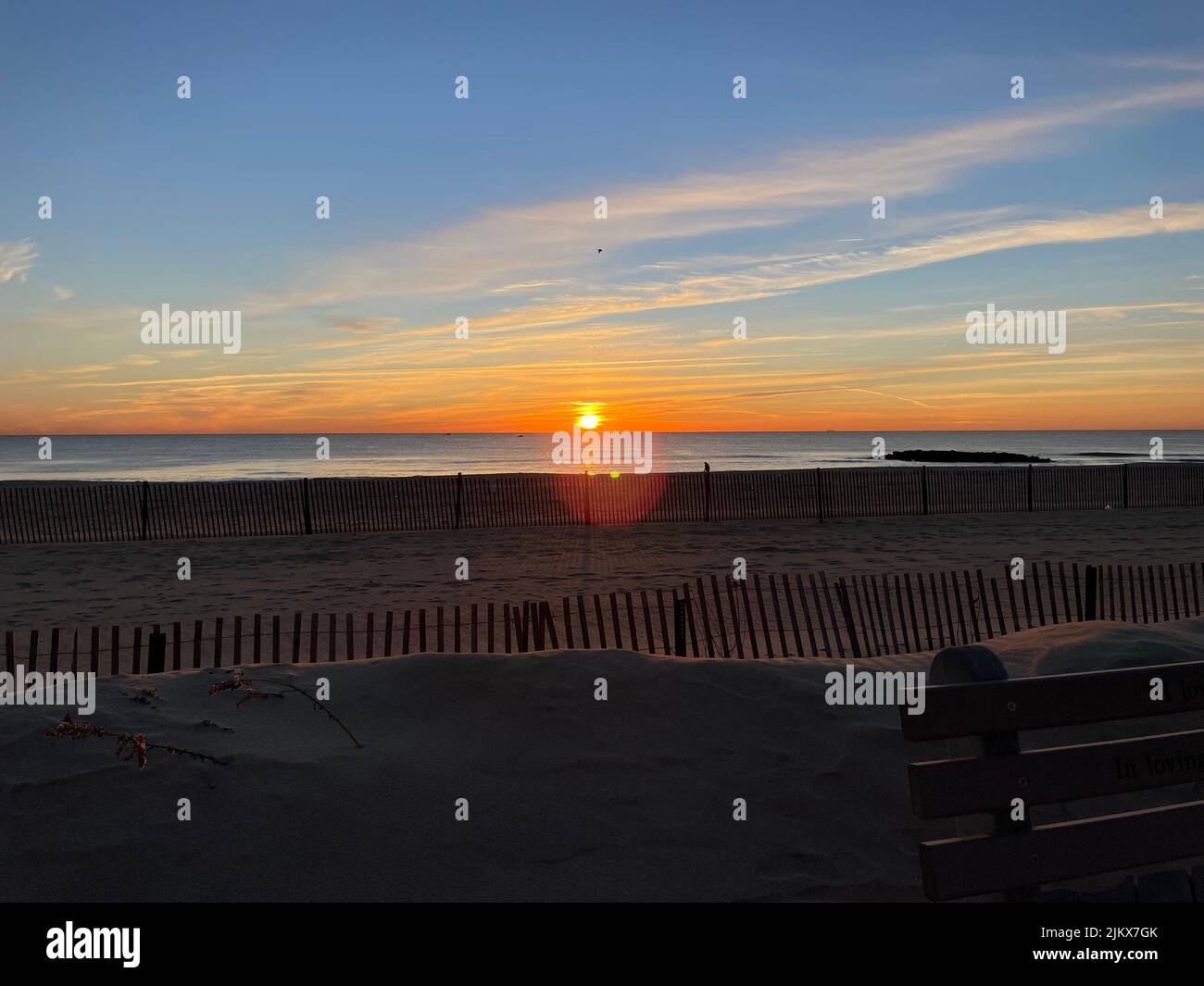 A sunset view over the sandy beach and the ocean Stock Photo - Alamy
