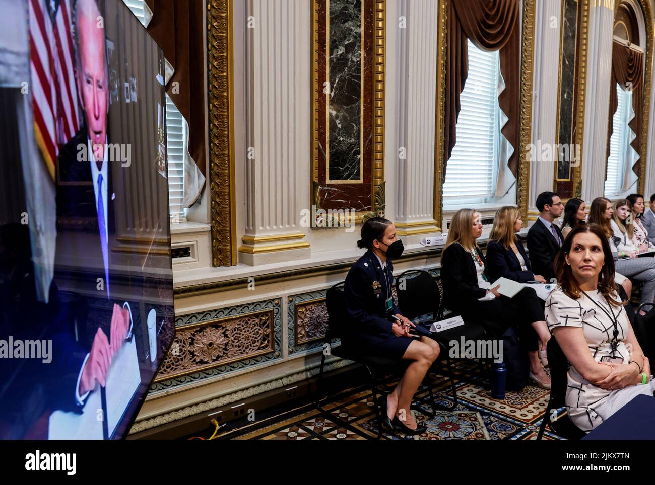 U.S. White House staff watch as U.S. President Joe Biden delivers remarks at a virtual event on securing access to reproductive and other health care services at the first meeting of the interagency Task Force on Reproductive Healthcare Access in the Indian Treaty Room in the Eisenhower Executive Office Building in Washington, U.S., August 3, 2022. REUTERS/Evelyn Hockstein Stock Photo