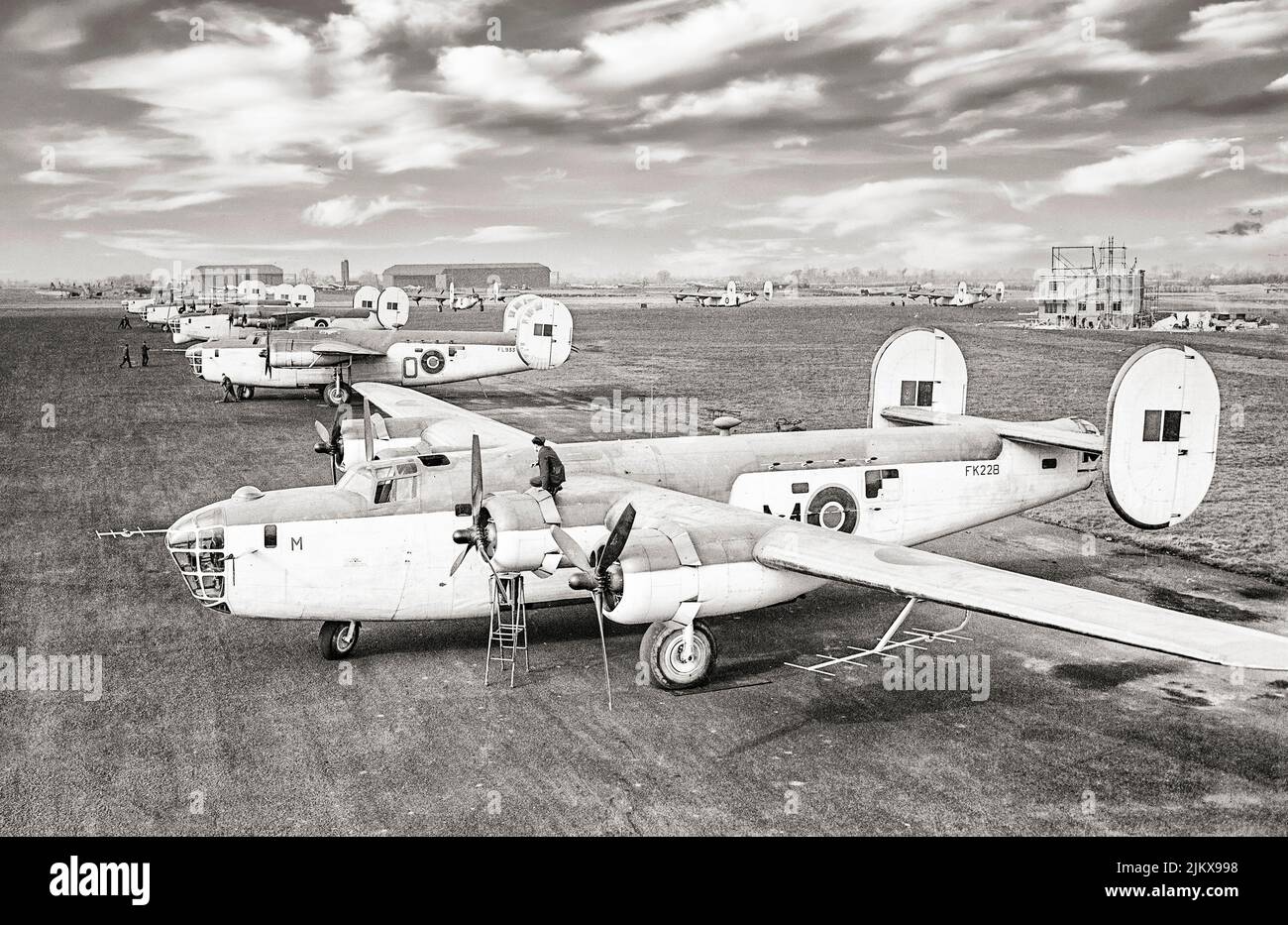 American heavy bombers, Consolidated B-24 Liberator GR Mark IIIs of No. 120 Squadron RAF, lined up with other aircraft at Aldergrove, County Antrim, Northern Ireland. The Mark IIIs are equipped with ASV Mark II anti-submarine radar, while the third aircraft in line, a GR Mark V of No. 86 Squadron RAF carries centrimetric ASV radar in a radome under the nose. Stock Photo