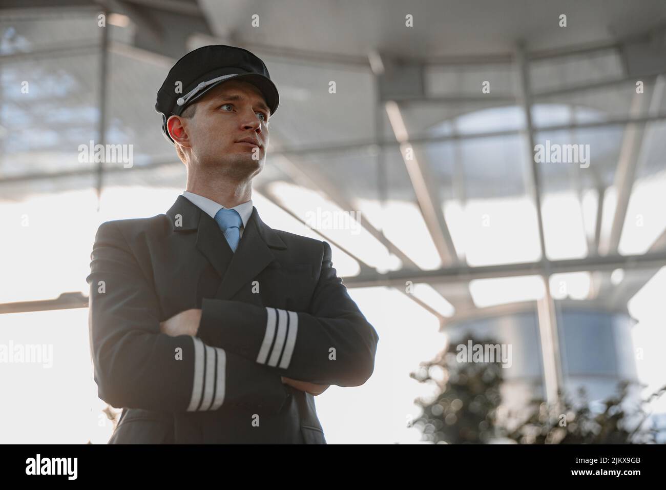Serious adult male pilot looking away in the airport Stock Photo