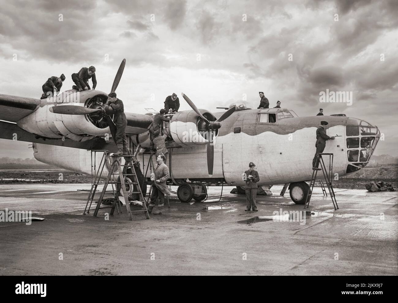 Daily inspection of a Consolidated B-24 Liberator III, an American heavy bomber at Beaulieu in Hampshire, England December 1942. At its inception, the B-24 was a modern design featuring a highly efficient shoulder-mounted, high aspect ratio Davis wing that gave the Liberator a high cruise speed, long range and the ability to carry a heavy bomb load. The B-24 was used extensively in World War II, serving in every branch of the American armed forces as well as several Allied air forces and navies in every theater of operations. Stock Photo