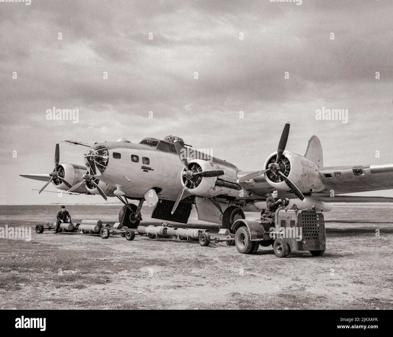 A  Boeing B-17 Flying Fortress II OF No 220 Squadron seen 'bombing up' with depth charges at Benbecula, in the Outer Hebrides, Scotland, May 1943. The  Fortress was a four-engined heavy bomber was a relatively fast, high-flying, long-range bomber with heavy defensive armament at the expense of bombload. It developed a reputation for toughness based upon stories and photos of badly damaged B-17s safely returning to base. In addition to its role as a bomber, the B-17 was also employed as a transport, antisubmarine aircraft, drone controller, and search-and-rescue aircraft. Stock Photo