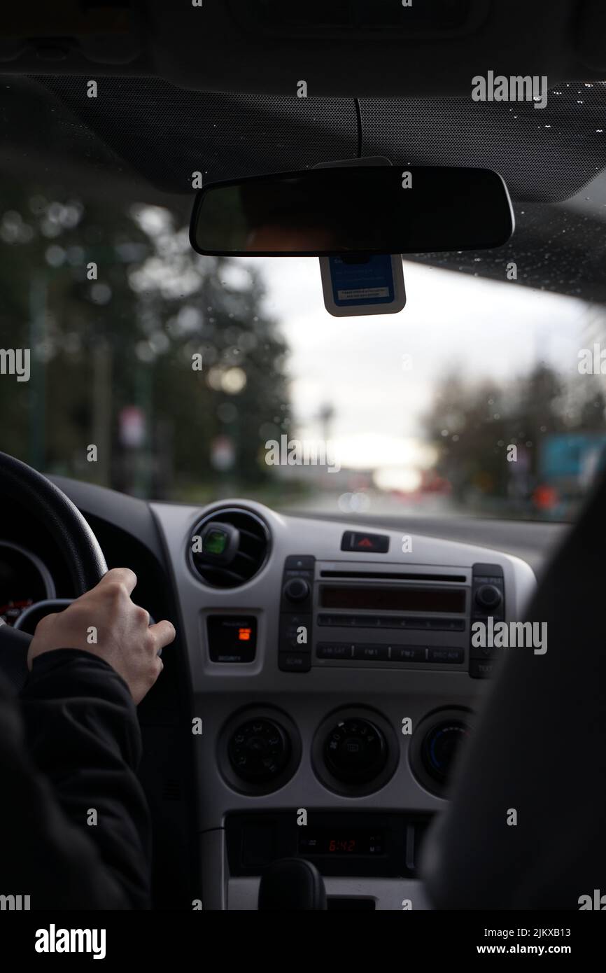 A vertical shot of the car interior while driving on the street with