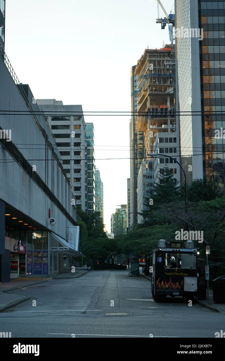 A vertical shot of tall modern buildings and a street in downtown