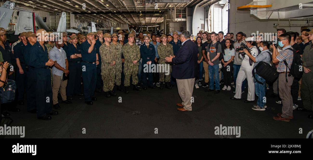 Singapore. 22nd July, 2022. Secretary of the Navy Carlos Del Toro meets with Sailors in the hangar bay of the U.S. Navy's only forward-deployed aircraft carrier USS Ronald Reagan (CVN 76). During Del Toro's visit, he held a press conference and addressed the crew over the ships 1MC. Ronald Reagan, the flagship of Carrier Strike Group 5, provides a combat-ready force that protects and defends the United States, and supports alliances, partnerships and collective maritime interests in the Indo-Pacific region. Credit: U.S. Navy/ZUMA Press Wire Service/ZUMAPRESS.com/Alamy Live News Stock Photo