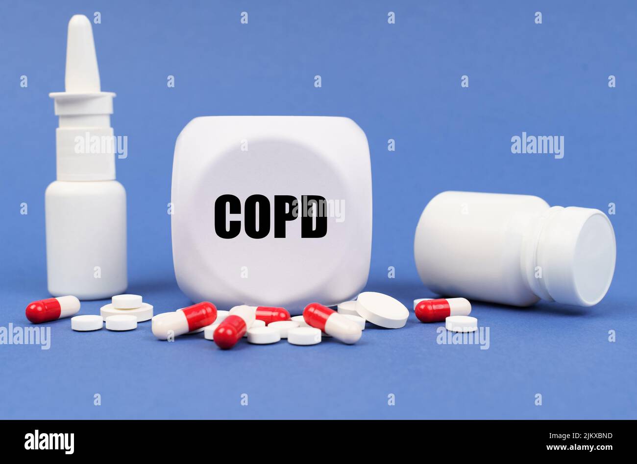 Medical concept. On the blue surface of the pill, capsule, spray, jar and cube with the inscription - COPD Stock Photo