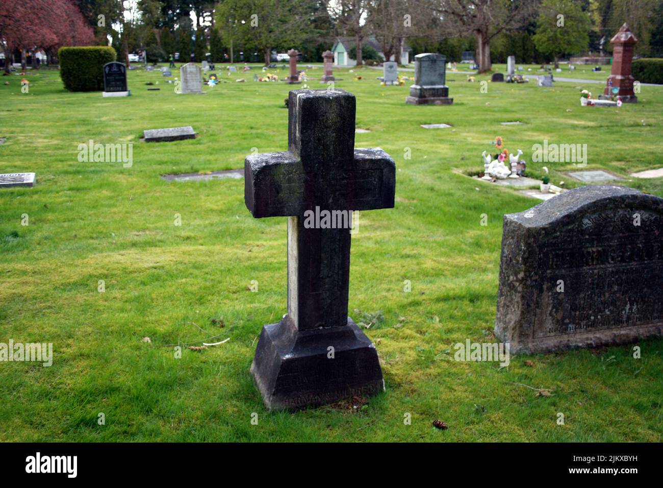 A cross Old tombstone in the graveyard in Langley cemetery, British Columbia, Canada Stock Photo