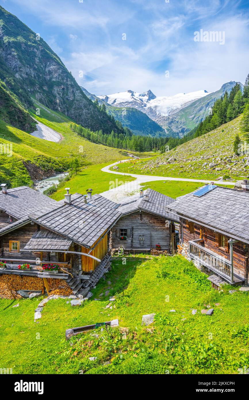 Idyllic alpine valley with cozy wooden rural houses Stock Photo - Alamy
