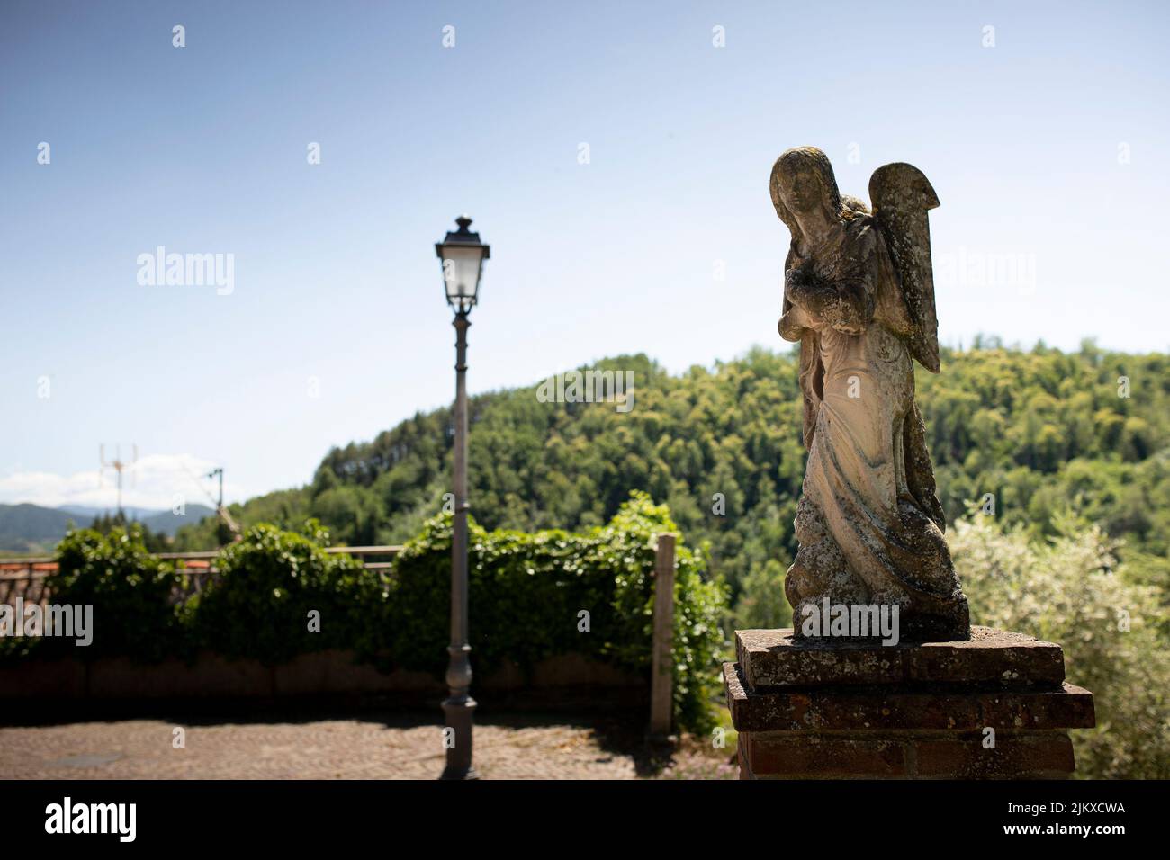 Statue of an angel outside Santa Maria and San Giorgio church in Fortunago, one of the most charming villages of Oltrepò Pavese, Lombardia countryside Stock Photo