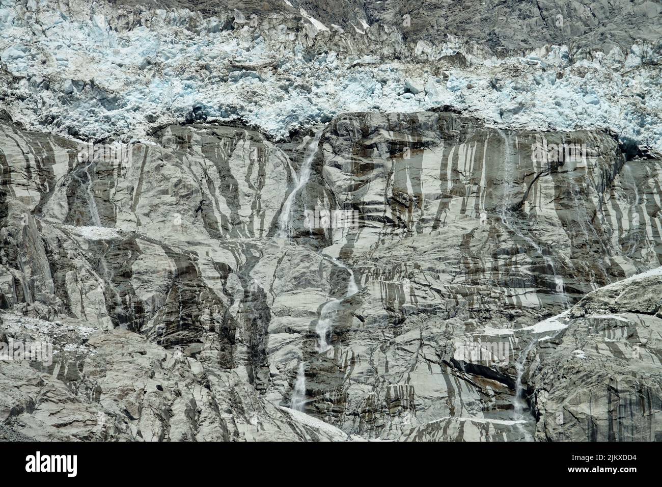 Climate change. View of the Brenva glacier melting creating large waterfalls. Courmayeur, Italy Stock Photo