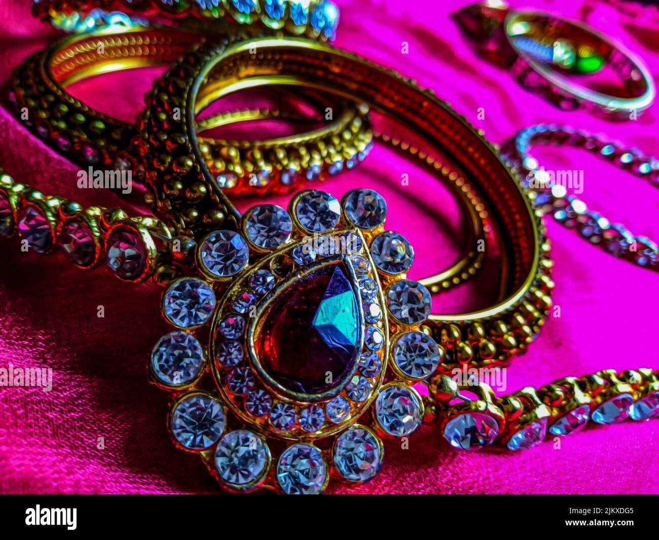 Stock photo of beautiful diamond waist belt,water drop shape brooch decorated with small white diamond, dark pink color diamond in the the middle of t Stock Photo