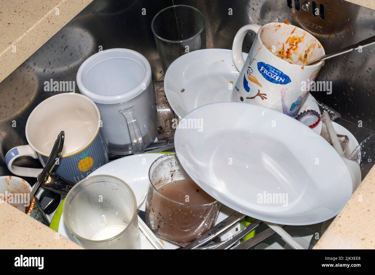 Kitchen dirty dishes, family living activities. Frozen cup. Kitchen commodities. Home living scenes. Kitchen mood or kitchen environment. Stock Photo