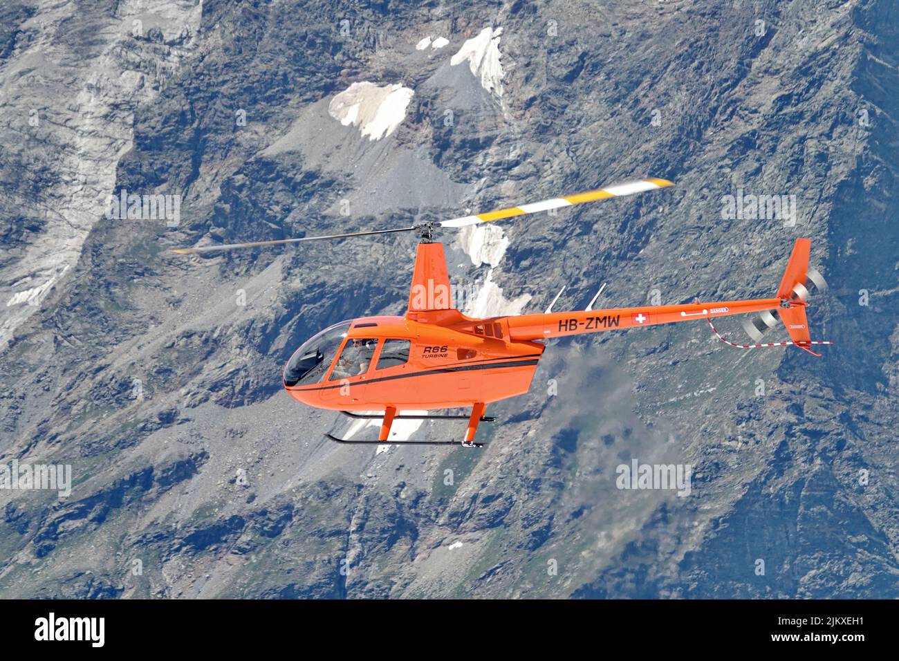 Helicopter flying in Swiss Alps mountain. Zermatt, Switzerland - August 2022 Stock Photo