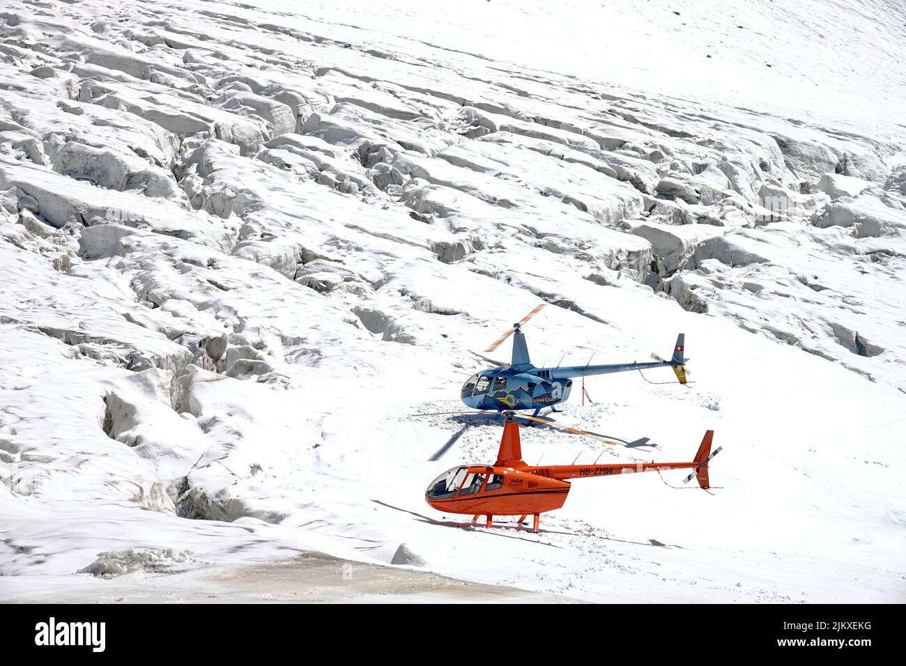 Helicopter flying in Swiss Alps mountain. Zermatt, Switzerland - August 2022 Stock Photo
