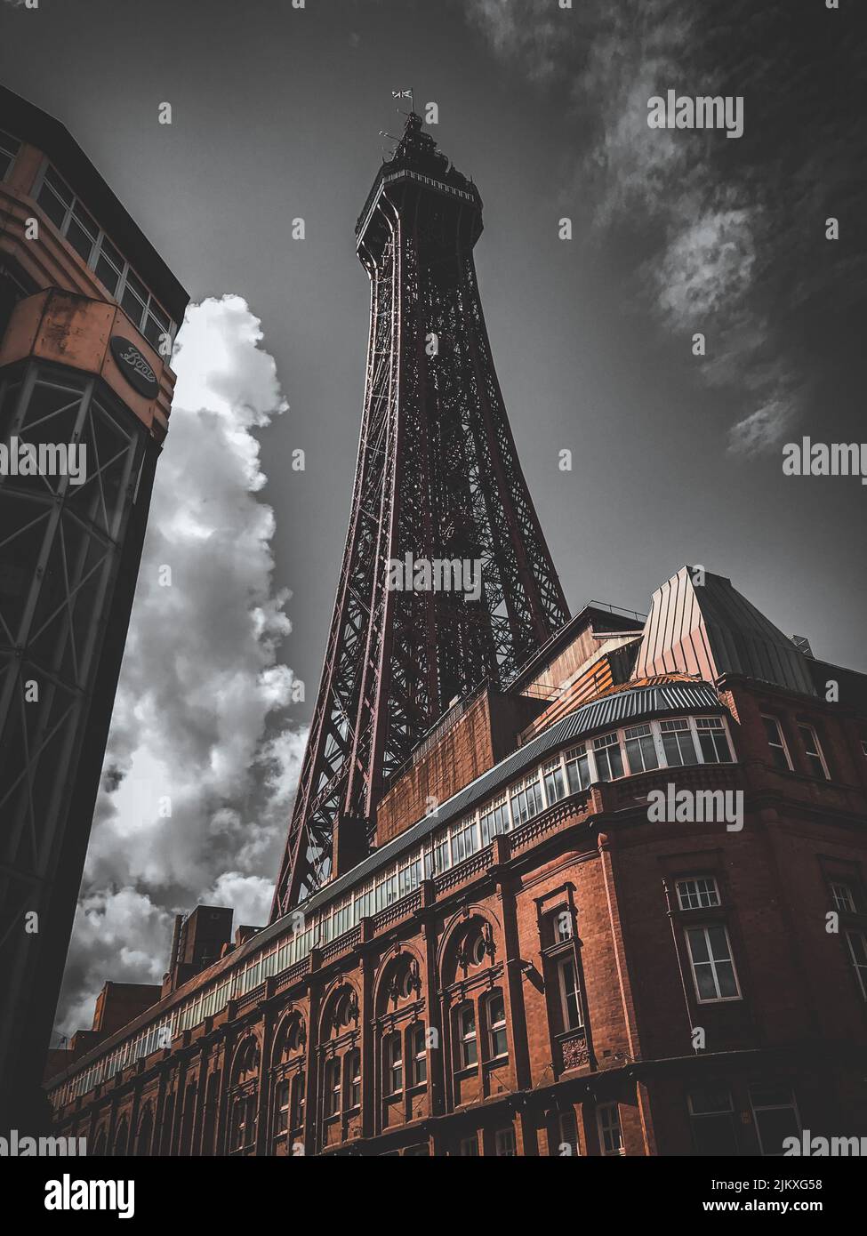 A vertical low angle shot of the Eiffel Tower under a cloudy sky Stock ...