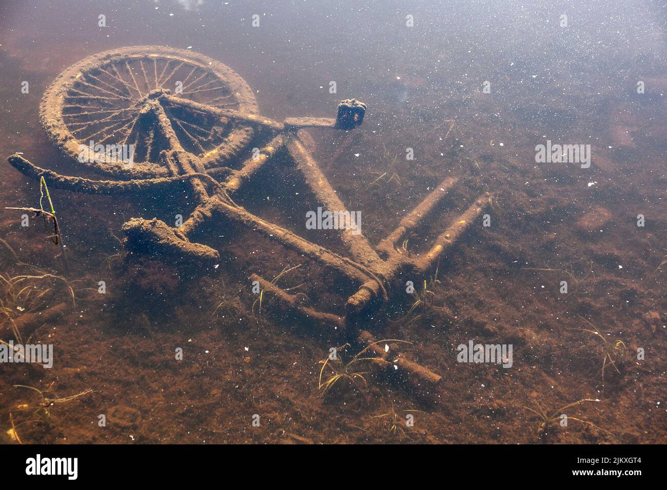Broken bicyle at the bottom of a river Stock Photo