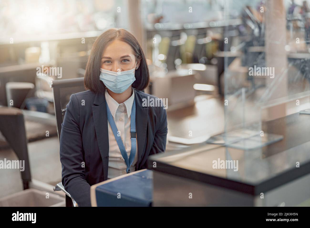 Female employee of the passport control department sitting at her desk Stock Photo