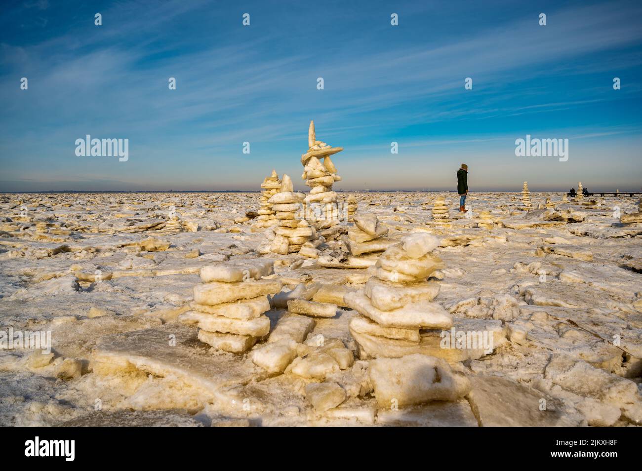 The stack of ice floes near the Wadden Sea in the cold northern hemisphere with a visitor Stock Photo