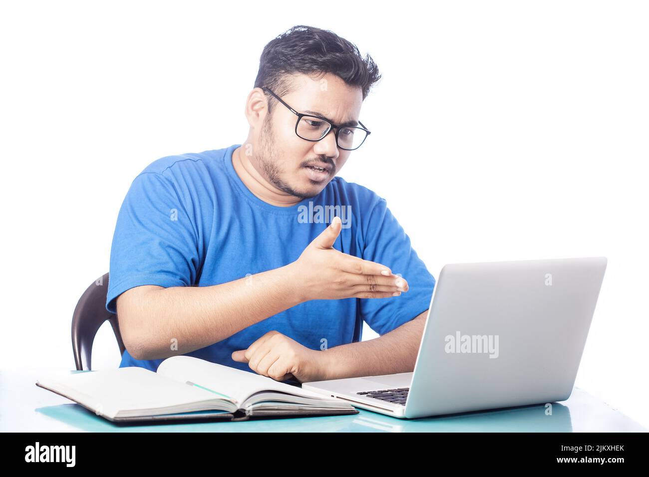 angry expression man talking over video calling on laptop Stock Photo