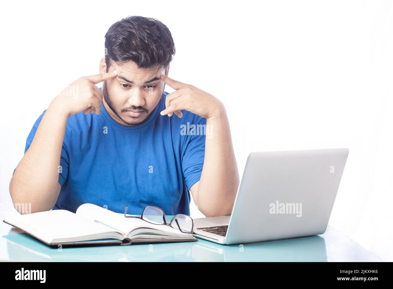 man having headache by working on laptop Stock Photo