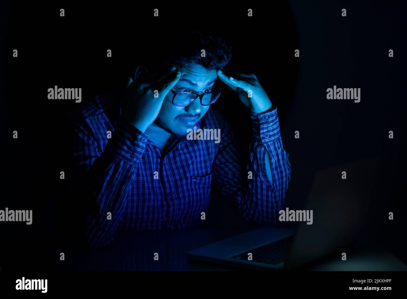 business man feeling tensed and headache looking at laptop screen at