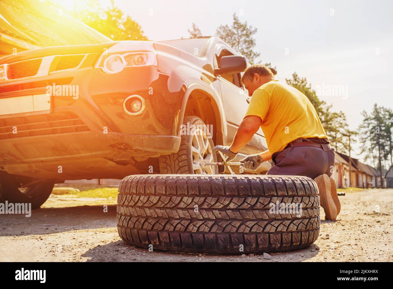 Replacing a spare wheel on the road with your own hands. The driver