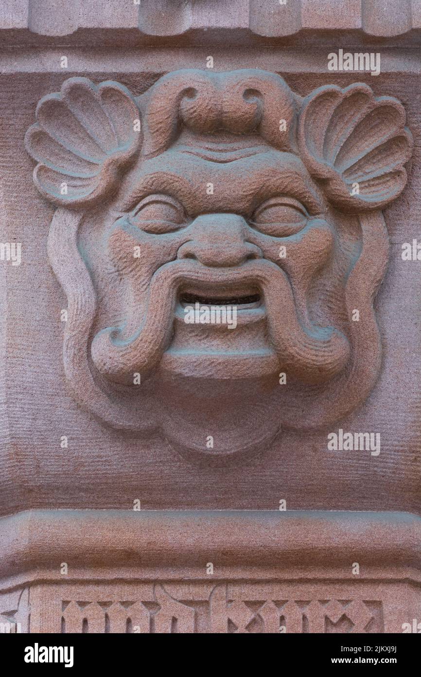 An architectural detail of a keystone above an arch, showing a green man carving. Stock Photo
