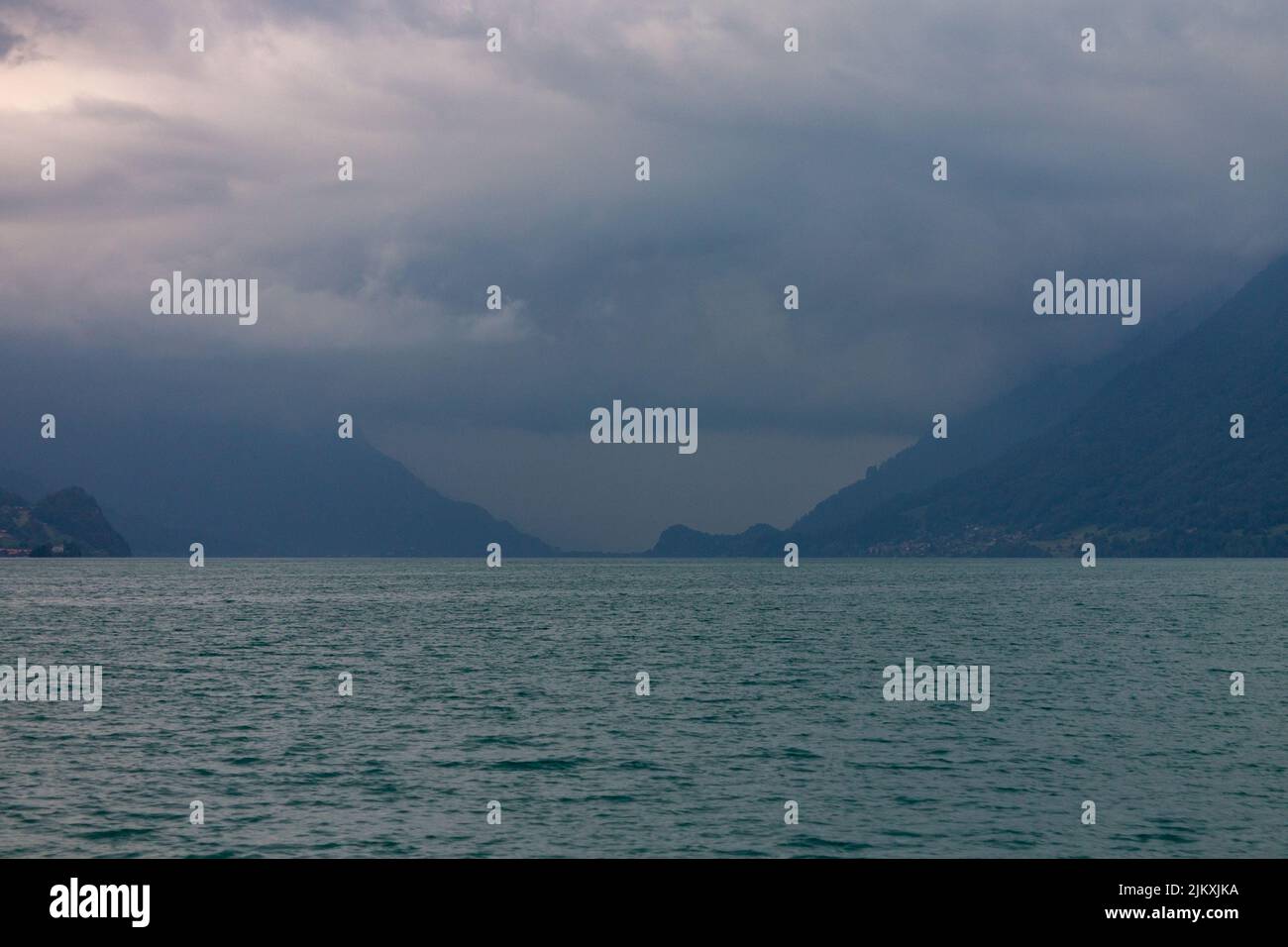 The view of Lake Brienz against the background of the Alps covered with ...