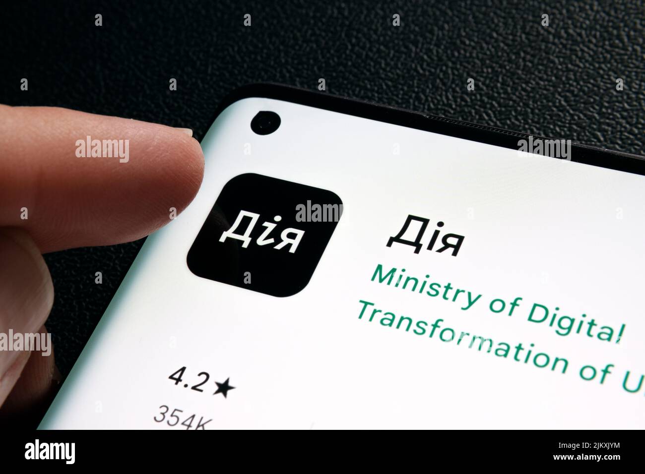 DIia app on smartphone screen. Ukrainian words seen on photo translate as 'Action', 'Action app'. 'Diia' app is the State in Smartphone project. Staff Stock Photo