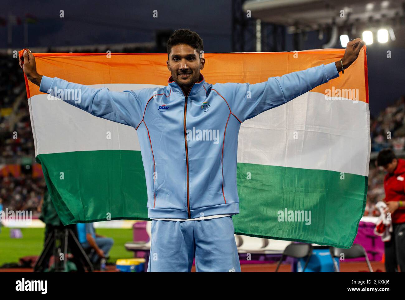 3rd August 2022; Alexander Stadium, Birmingham, Midlands, England: Day 6 of the 2022 Commonwealth Games: Tejaswin Shankar (IND) with his national flag after winning the Bronze medal in the Men's High Jump Final with a height of 2.22m Stock Photo