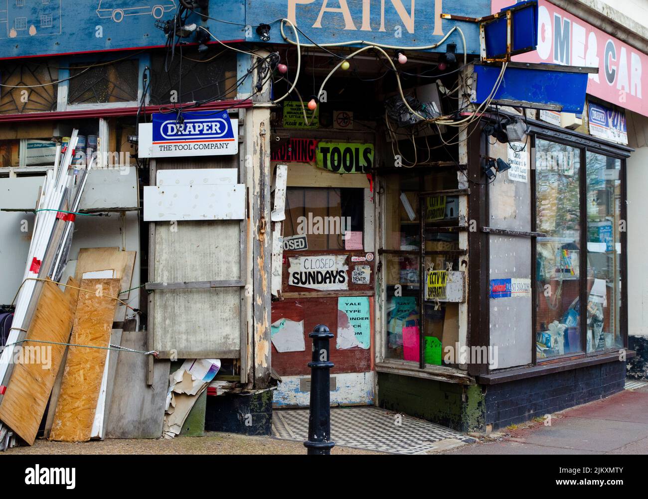 An old fashioned hardware store with multiple bright and torn signs