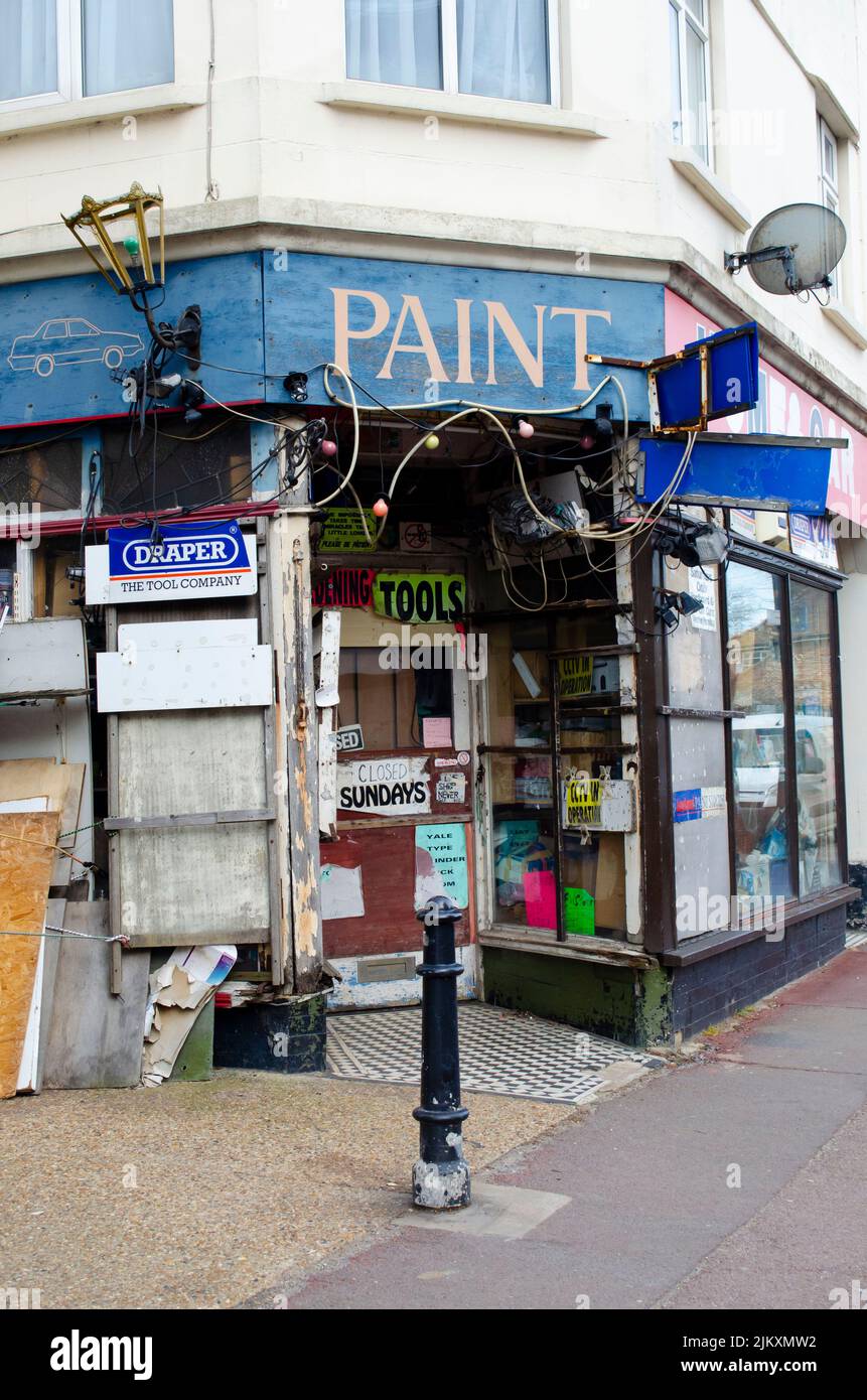 An old fashioned hardware store with multiple bright and torn signs
