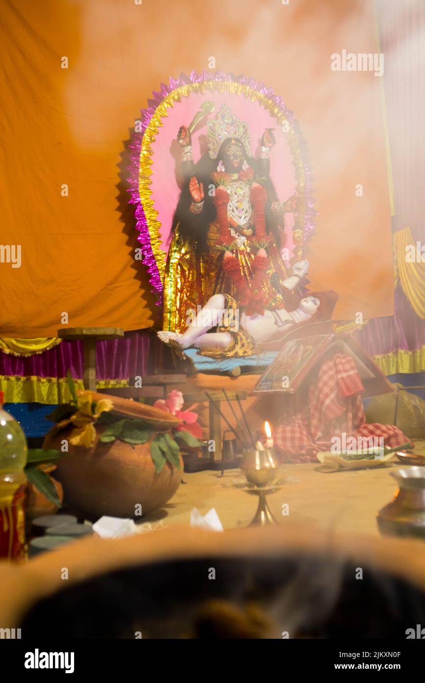 Smoke from a dhupbatti (Incense burner) infront of Maa kali. The