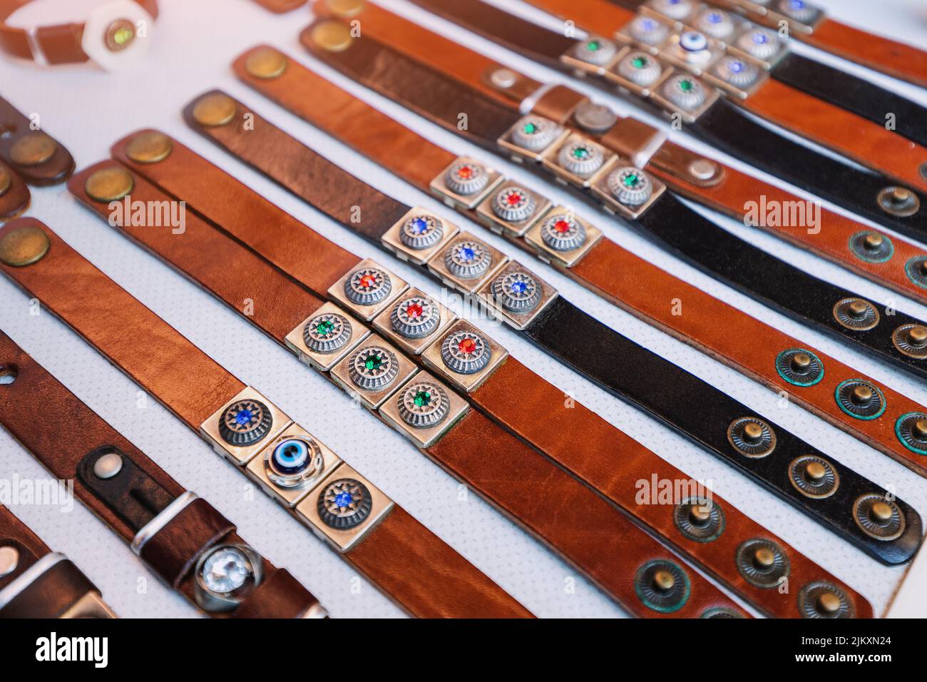 Trendy handmade leather bracelets and wristbands for sale at artisans market. Handcraft souvenir at flea market. Purchase of elegant souvenirs Stock Photo