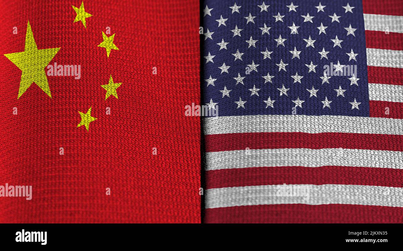 Flags of China and United States on folded fabric. Concept of political relations and tension between the two entities. Stock Photo