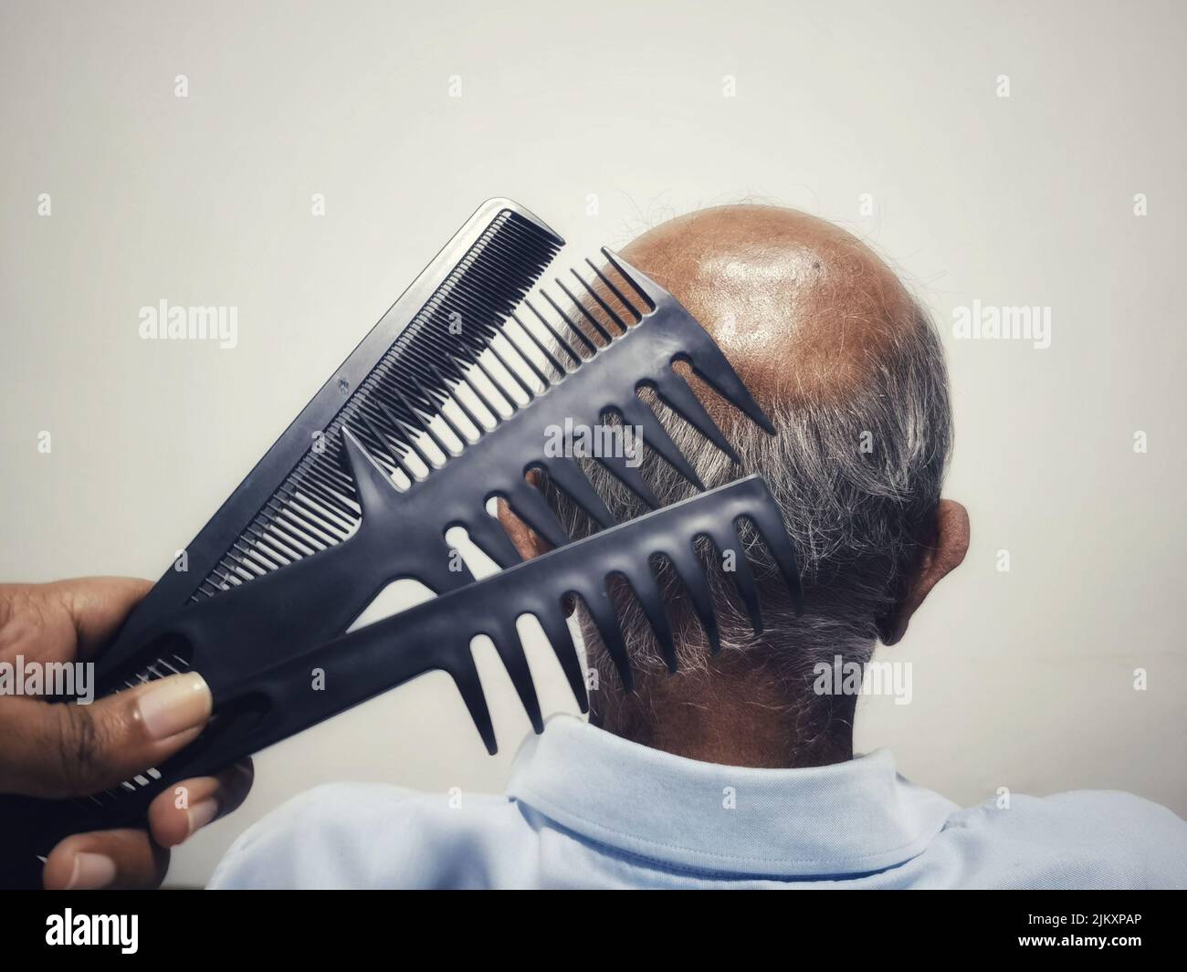 An occipital area of an old man with multiple combs in front Stock Photo