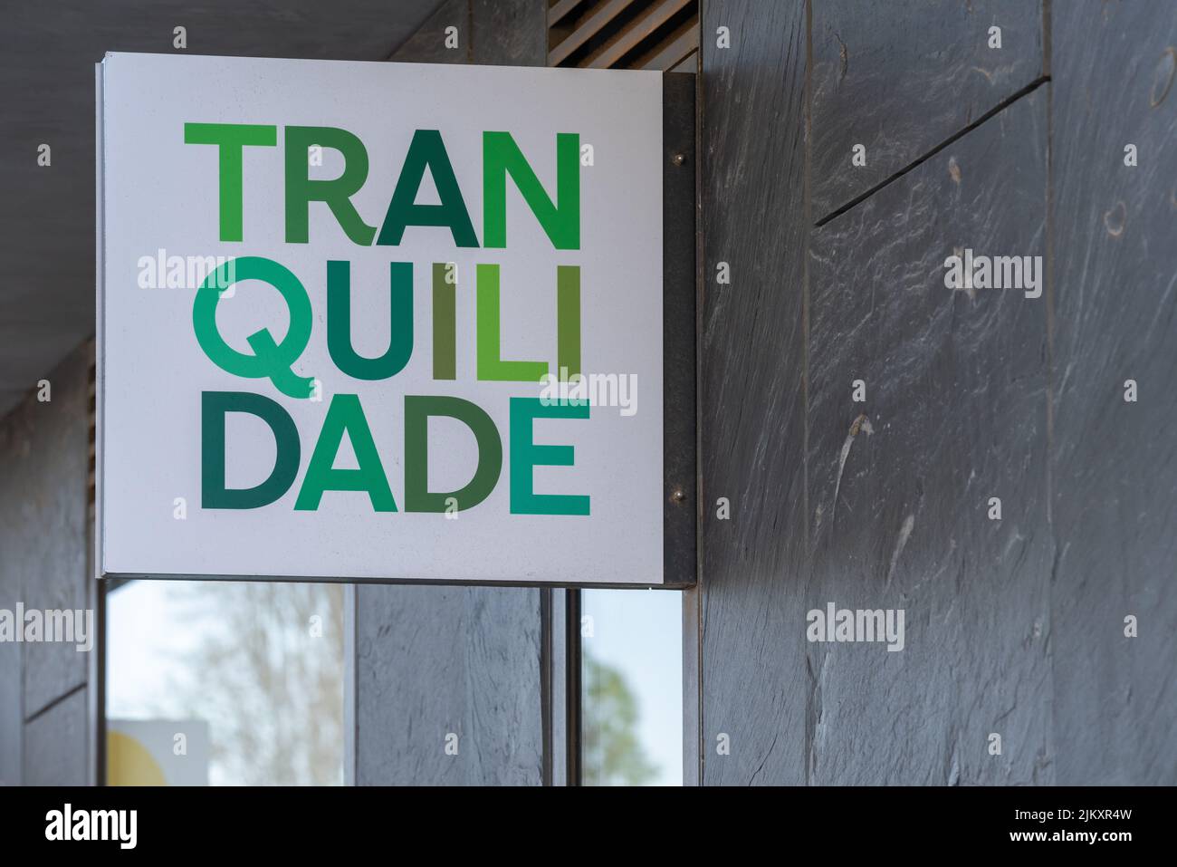 A green sign for the insurance company Tranquilidade in Lisbon, Portugal Stock Photo