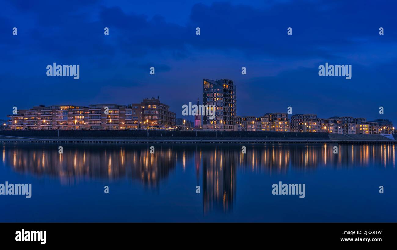 The view of the night city with the reflection on the water surface ...
