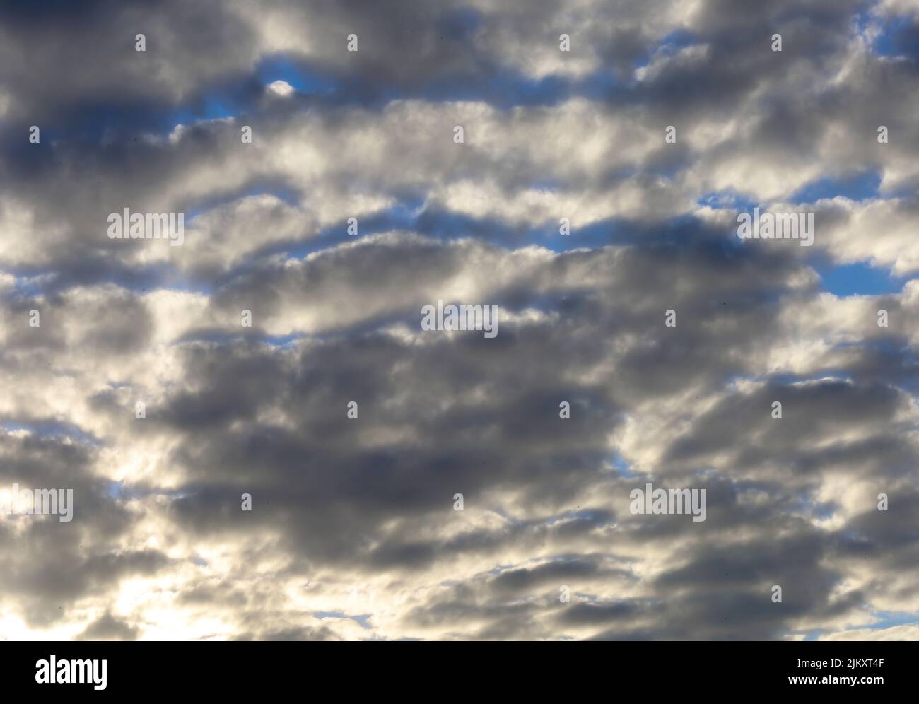 Dramatic Sunburst in White and Grey Clouds Stock Photo