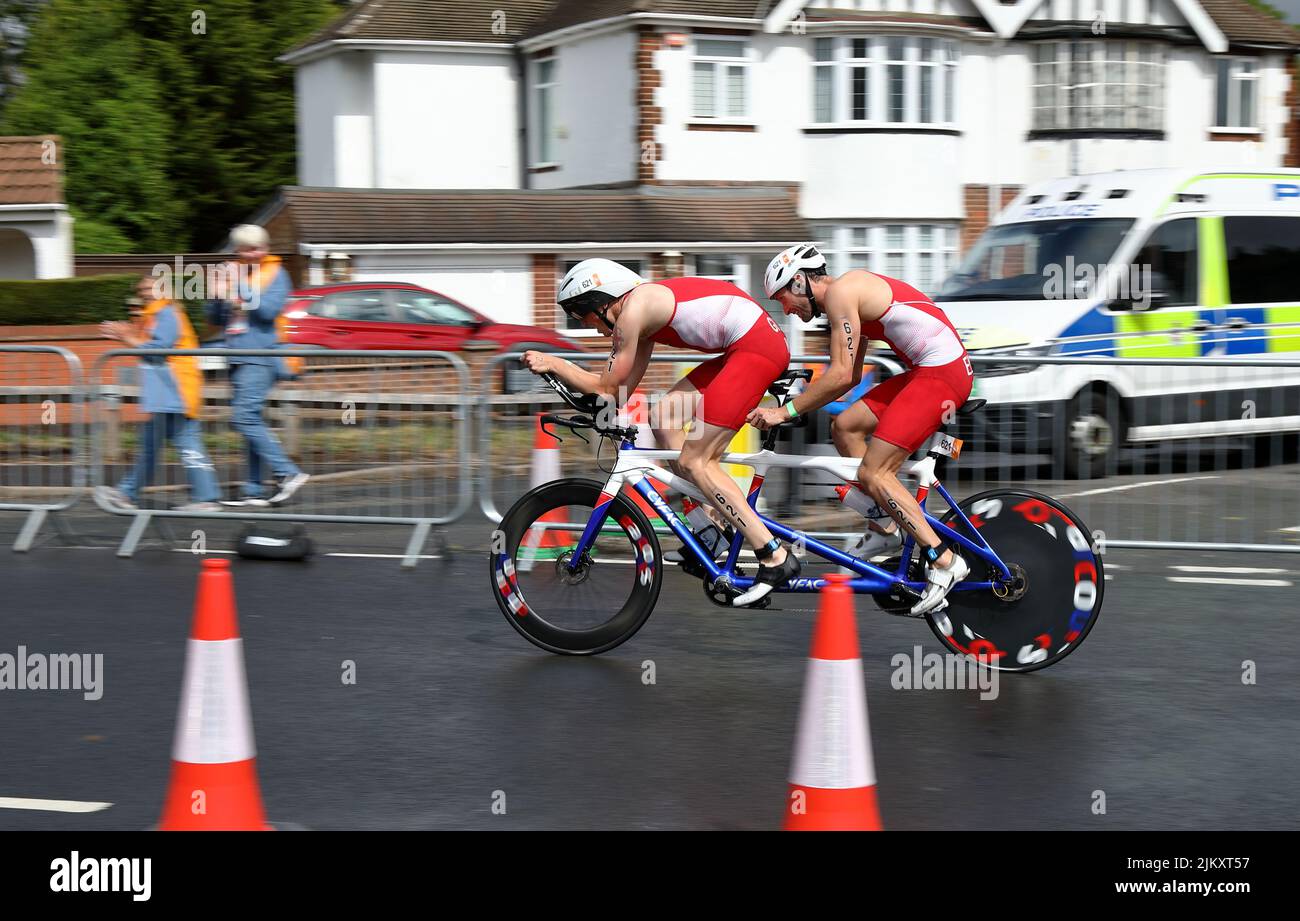 Dave Ellis and guide competing in the bike stage of the 2022 Birmingham Commonwealth Games Paratriathlon event. Stock Photo