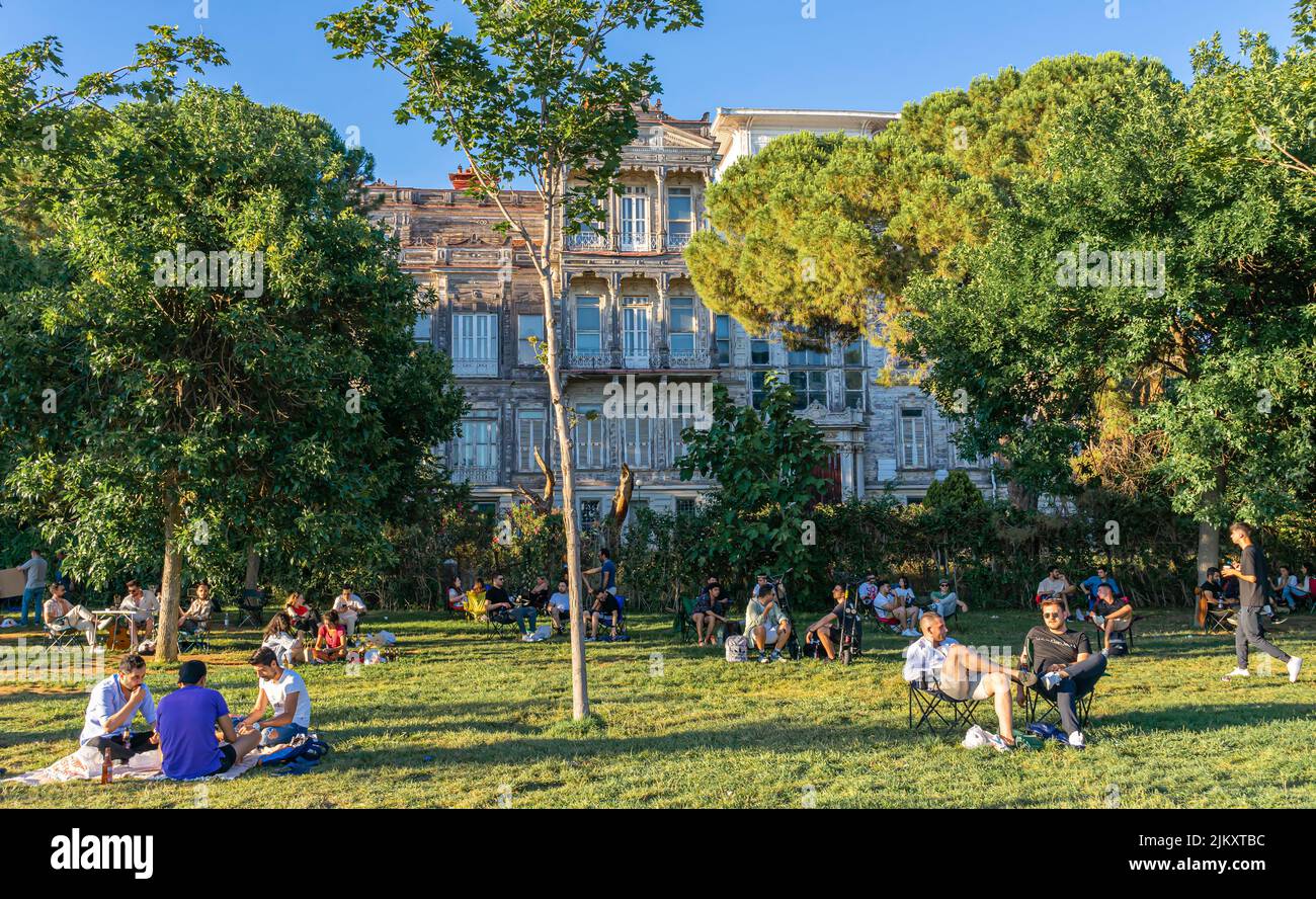 Tourists camping on the grass near Ragıp Paşa Mansion built in 1906 by August Jasmund. Caddebostan, Kadikoy, Istanbul, Turkey Stock Photo