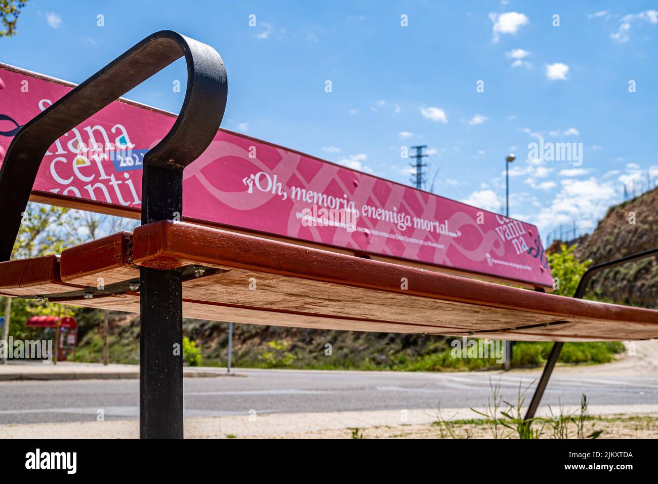 Arganda del Rey, Spain. April 18, 2022. Wooden bench decorated with a vinyl with a phrase of the historical book of Cervantes called 'Don Quixote', on Stock Photo