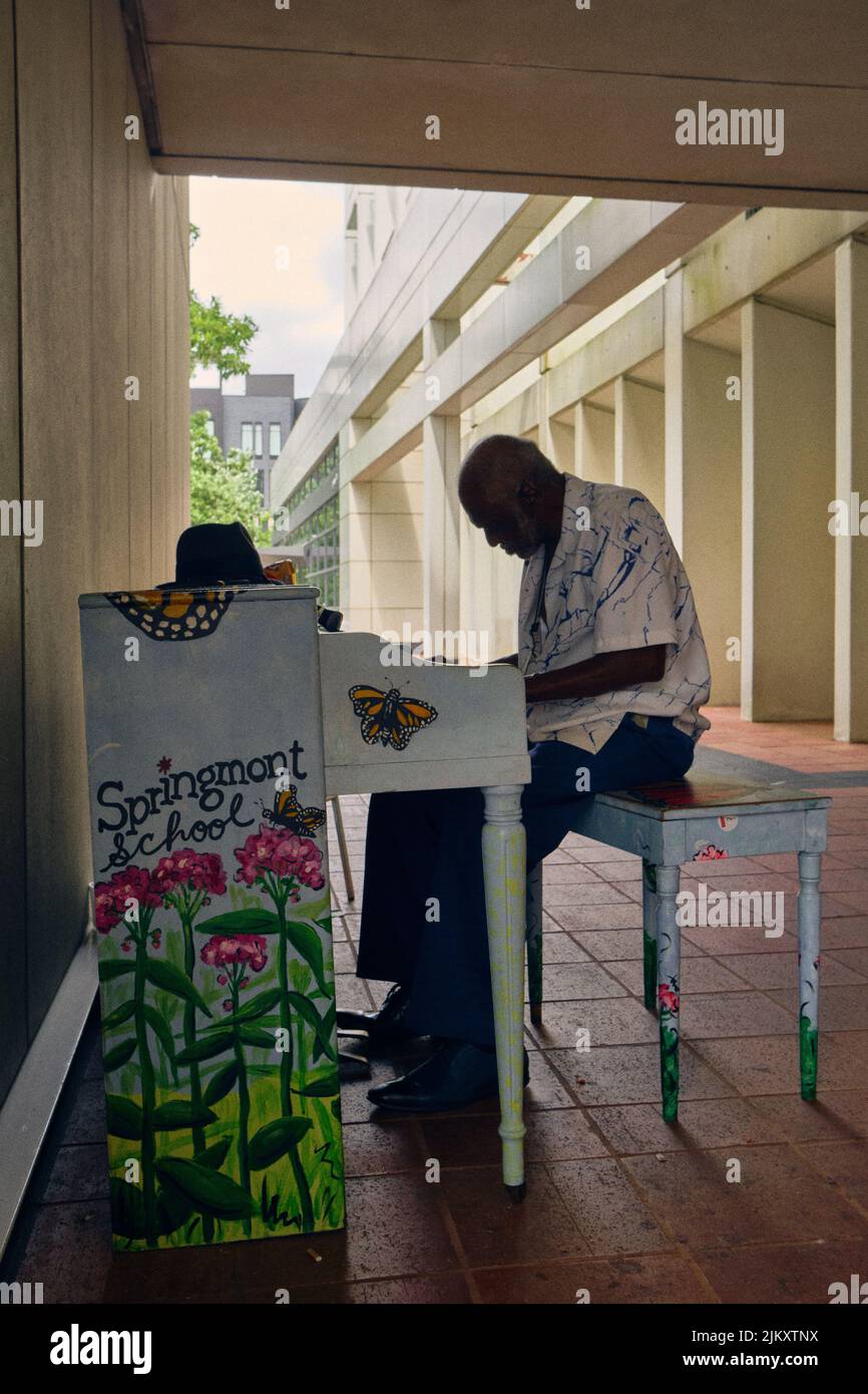 An elderly gentleman playing the piano in Downtown Atlanta Stock Photo
