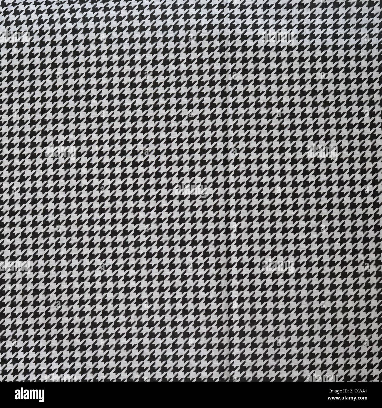 A closeup shot of a Houndstooth puppy tooth wool fabric - perfect for wallpapers Stock Photo