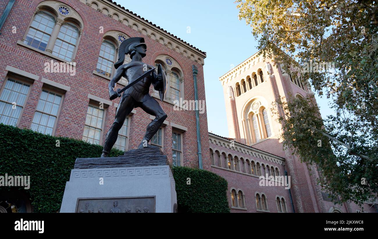 A low angle shot of the Tommy Trojan statue and Bovard Hall at the University of Southern California (USC) in Los Angeles Stock Photo