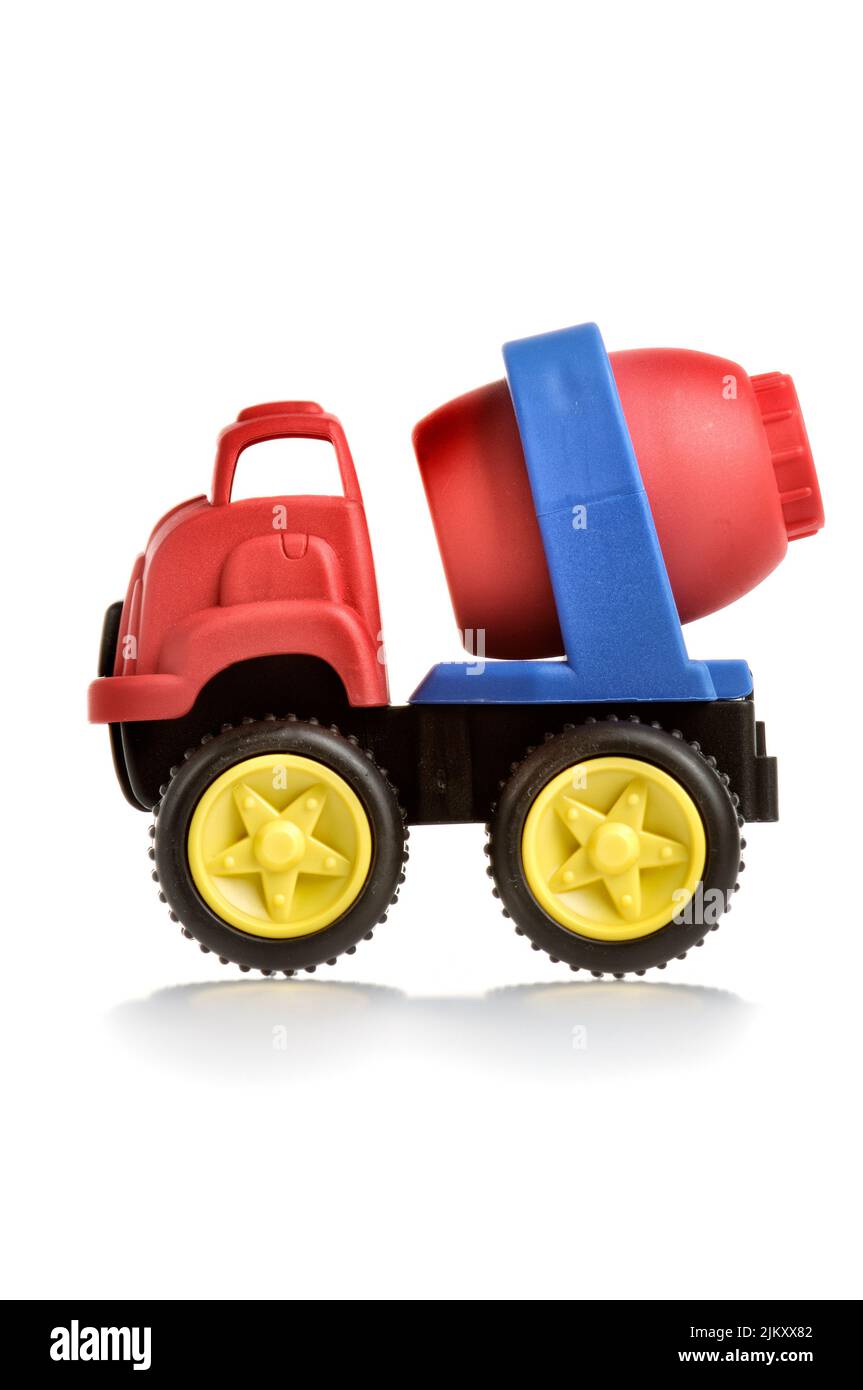 A vertical shot of a red and blue plastic toy cement truck on a white