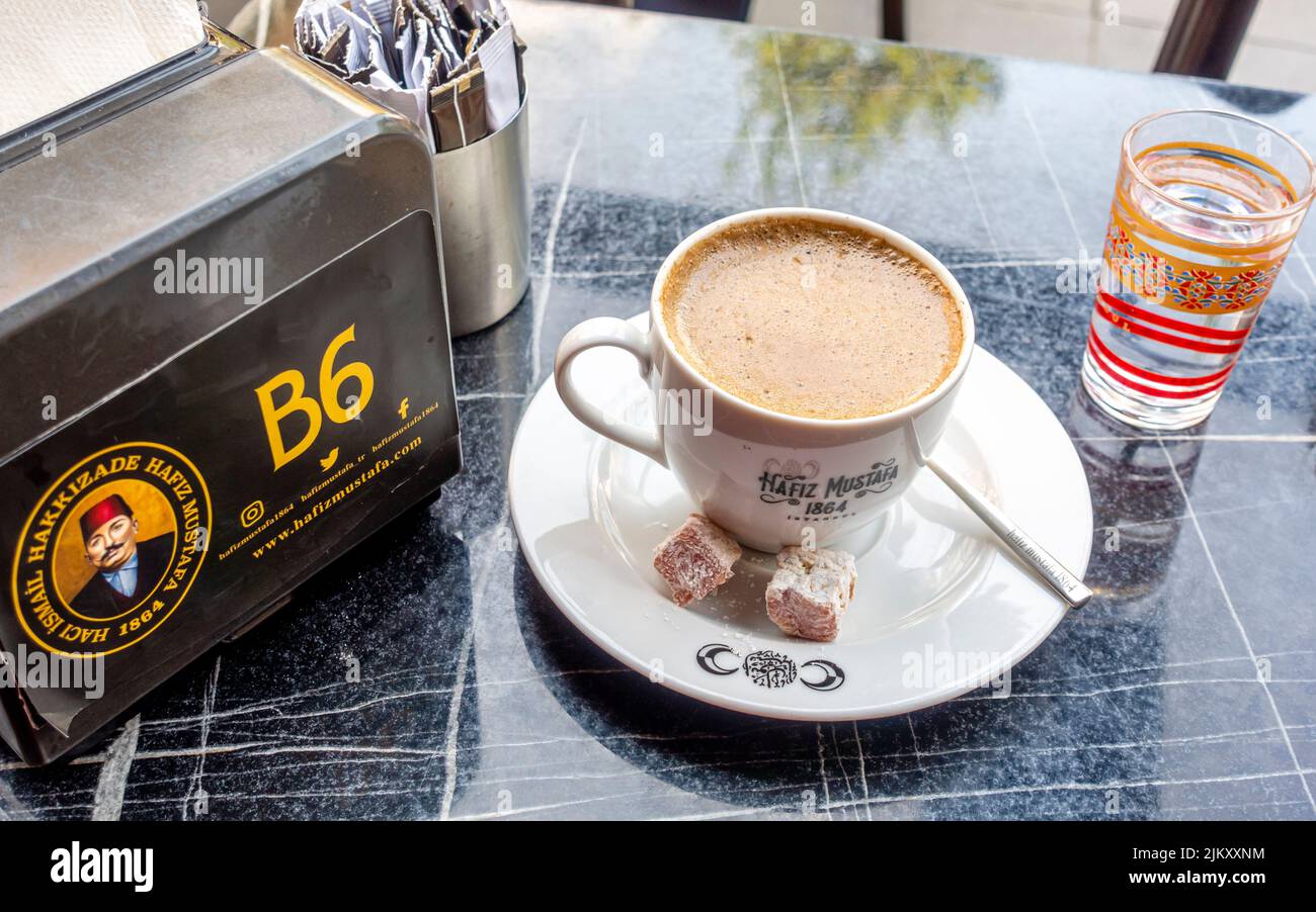 A cup of cappuccino, branded logo in Hakkı Zade Hafiz Mustafa 1864 - $Pastry shop and cafe in Fatih, Istanbul, Turkey Stock Photo